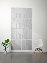 Gray rectangular tiles with vertical engraved lines arranged in offset pattern on wall.