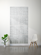 A 12-panel wall mirror set with a textured silver and white marble pattern, styled in a minimalist room with a white chair and a green potted plant.