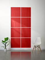 Eight red tiles with vertical engraved lines arranged in a 2x4 grid with offset pattern on white wall.