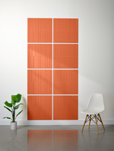 Eight terra cotta tiles with vertical engraved line pattern arranged in offset grid layout on wall.