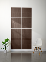 Brown rectangular tiles with vertical line engraving arranged in offset pattern on white wall.