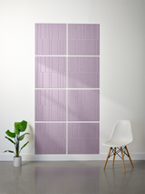 Four lavender tiles with vertical line engraving pattern arranged in offset configuration on wall.