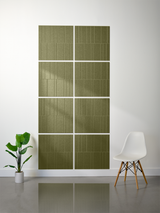 Olive green rectangular tiles with vertical engraved line pattern arranged in offset grid layout on wall.