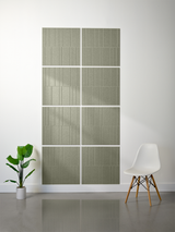 Eight sage green tiles with vertical engraved lines arranged in offset 2x2 pattern on wall.