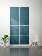 Eight teal tiles with vertical engraved lines arranged in an offset grid pattern on a wall.