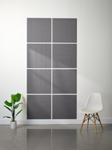 Gray subway tiles arranged in a 2x4 grid pattern with engraved curved line designs on each tile.