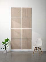 Beige subway tiles with engraved curved line patterns arranged in a 2x4 grid on a white wall.