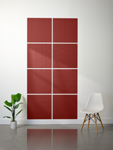 Red subway tiles arranged in 2x2 grid with engraved curved line pattern, displayed on wall.