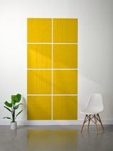 Eight bright yellow subway tiles arranged in a 2x4 grid with engraved curved line patterns and white grout lines.