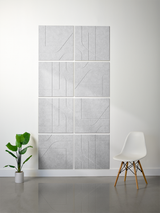 Light gray subway tiles with engraved curved and linear patterns arranged in a 2x4 grid on a wall.