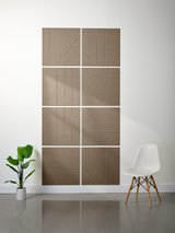 Eight tan subway tiles with engraved geometric line patterns arranged in a 2x4 grid on a wall.