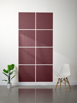 Eight burgundy subway tiles with engraved geometric line patterns arranged in a 2x4 grid on a white wall.