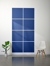 Blue subway tiles with engraved geometric line patterns arranged in a 2x4 grid layout on a wall.