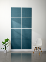Teal subway tiles with engraved geometric line patterns arranged in a 2x4 grid on white wall.