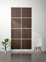 Brown subway tiles with engraved geometric line patterns arranged in a 2x4 grid on a wall.