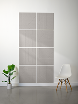 Gray subway tiles with engraved curved and linear patterns arranged in a 2x4 grid on a wall.