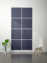 Eight dark blue subway tiles arranged in a 2x4 grid, each engraved with geometric line patterns that connect across tiles.