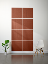 Eight terracotta ceramic tiles arranged in a grid with engraved curved and linear patterns throughout.