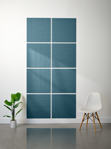 Eight blue-gray subway tiles with engraved curved and linear patterns arranged in a 2x4 grid on a wall.