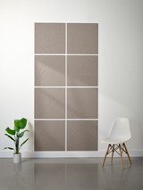 Eight taupe tiles with engraved topographic line pattern arranged in 2x4 grid on wall.