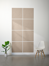 Square beige tiles arranged in a grid with engraved topographic contour line patterns.