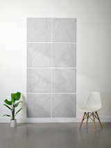 Eight light gray tiles with engraved topographic contour line pattern arranged in a 2x4 grid on wall.