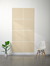 Eight beige tiles with engraved topographic line patterns arranged in a 2x4 grid on a wall.