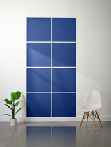 Eight blue tiles with engraved topographic contour line patterns arranged in a 4x2 grid on wall.