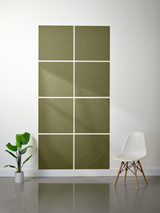 Eight olive-green square tiles with engraved topographic line patterns arranged in a 2x4 grid on a white wall.