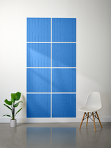 Set of eight blue tiles with engraved geometric arc patterns arranged in a grid on a wall.