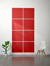 Eight red tiles with engraved geometric arch and line patterns arranged in a grid on a wall.