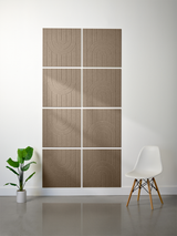 Eight tan tiles with vertical lines and engraved arch patterns arranged in a 2x4 grid on a wall.