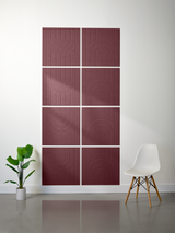 Eight burgundy tiles with engraved curved line patterns arranged in a 2x4 grid on a wall.