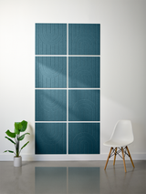 Eight teal tiles with engraved geometric arch patterns arranged in a 2x4 grid on a wall.