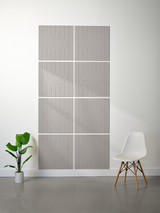 Set of eight gray tiles with engraved geometric arc and line patterns arranged in a 2x4 grid on a wall.