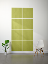 Green tiles with engraved geometric arch patterns arranged in an eight-tile grid on a wall.