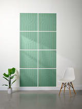 Four green tiles arranged in a 2x2 grid with engraved geometric arch patterns and vertical lines.