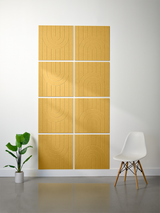 Eight gold tiles arranged in a grid with engraved geometric arch patterns and vertical lines.