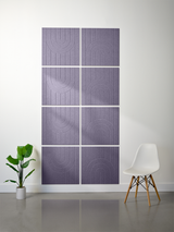 Gray tiles with engraved geometric arc patterns arranged in a 2x4 grid on a wall.