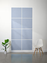 Blue-gray tiles with vertical engraved line pattern arranged in a 2x4 grid on white wall.