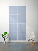 Eight light blue subway tiles arranged in a 2x4 grid with engraved curved line patterns.