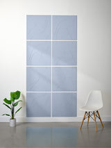 Eight square blue-gray tiles arranged in a grid with engraved topographic contour line patterns.