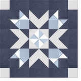 Geometric quilt pattern with navy, white, and light blue triangles and squares arranged in symmetrical star design.