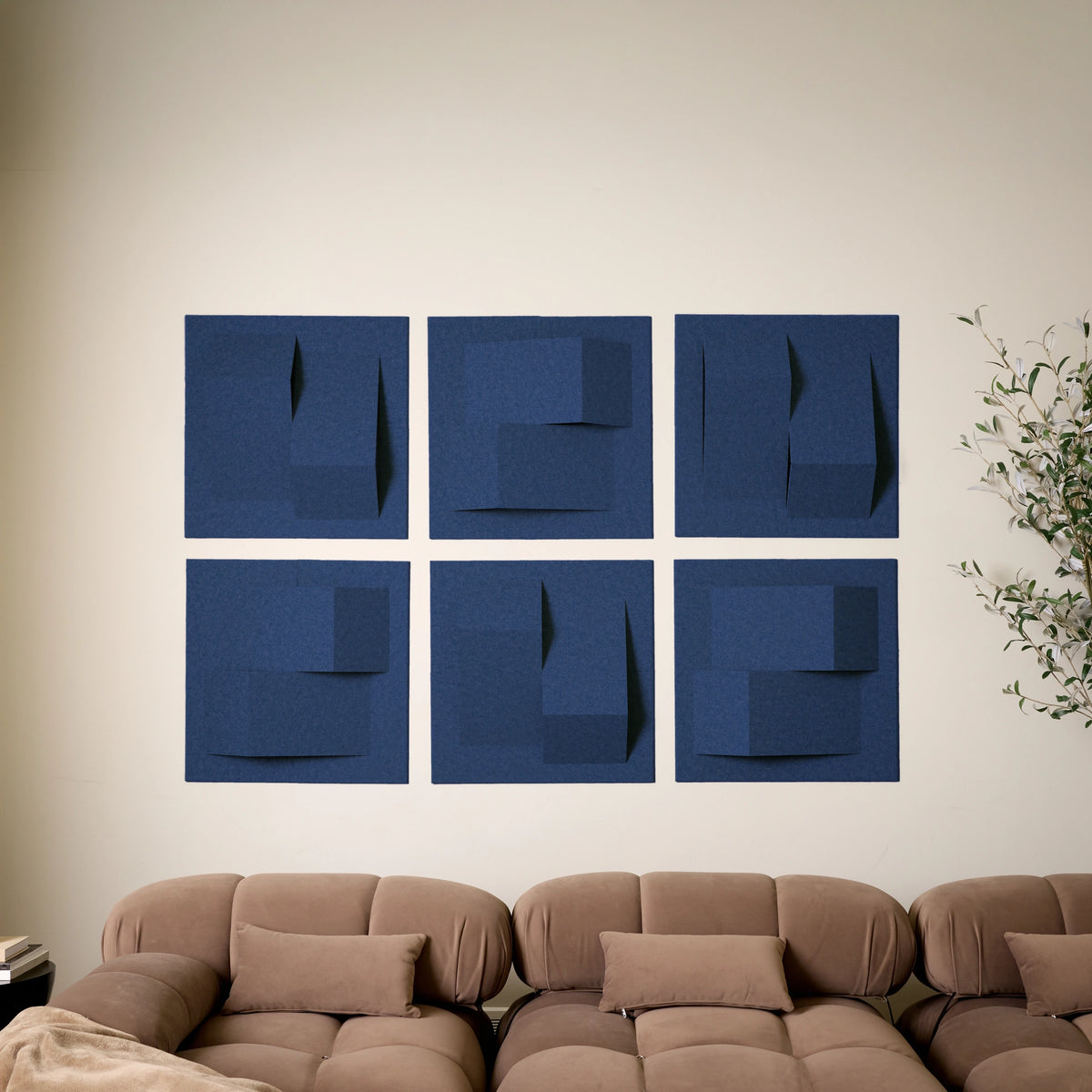 Blue acoustic felt tiles above a brown couch