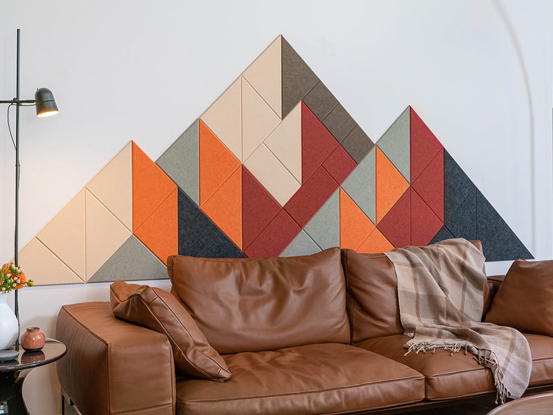 Brown leather sofa with a geometric wall art panel in a living room setting.