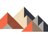 Geometric mountain peaks in shades of coral, cream, brown, gray, and charcoal with visible shading and faceted surfaces.