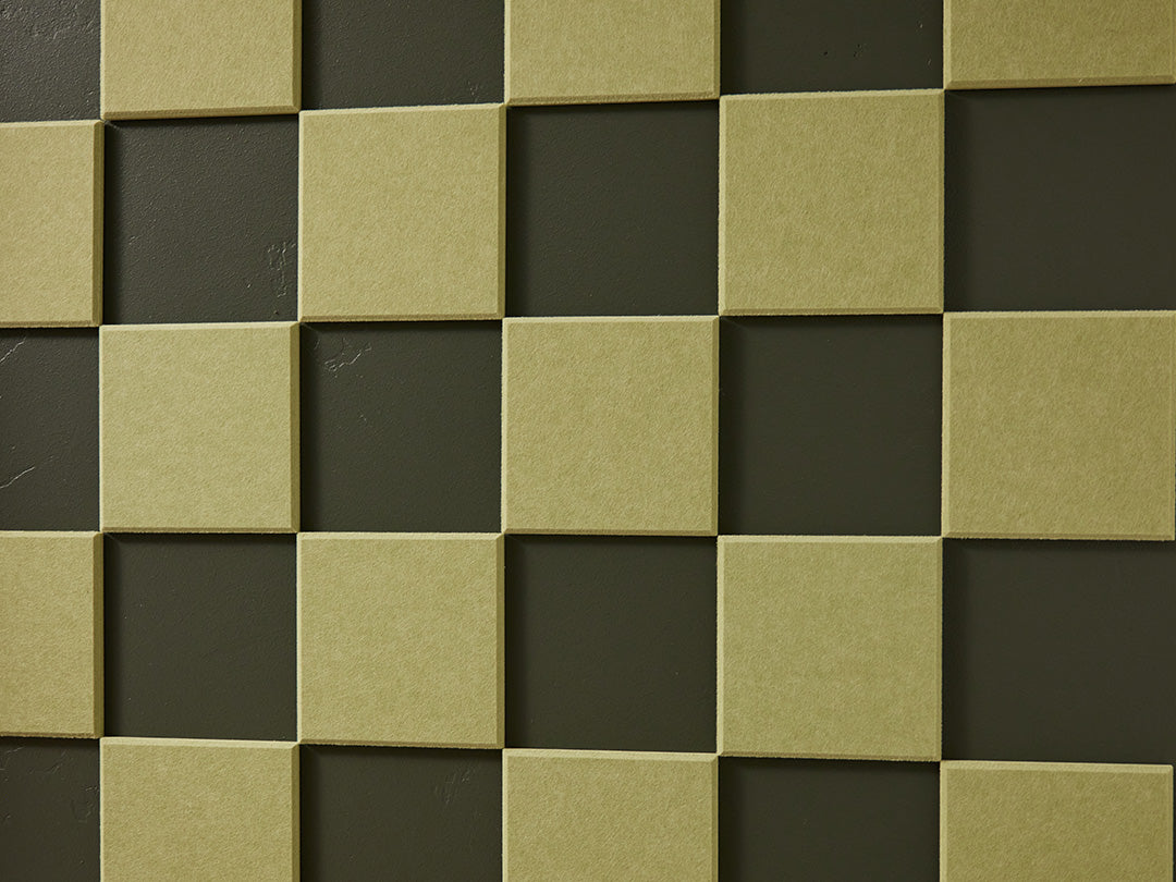 A Felt Right wall art design in a shade of green square felt tiles in a checkered pattern on a dark green wall
