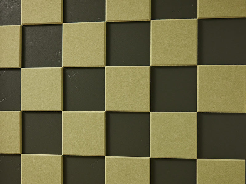 A Felt Right wall art design in a shade of green square felt tiles in a checkered pattern on a dark green wall