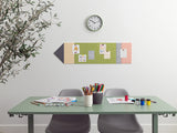 Desk with stationery items, a wall clock, and a decorative plant in an office setting.