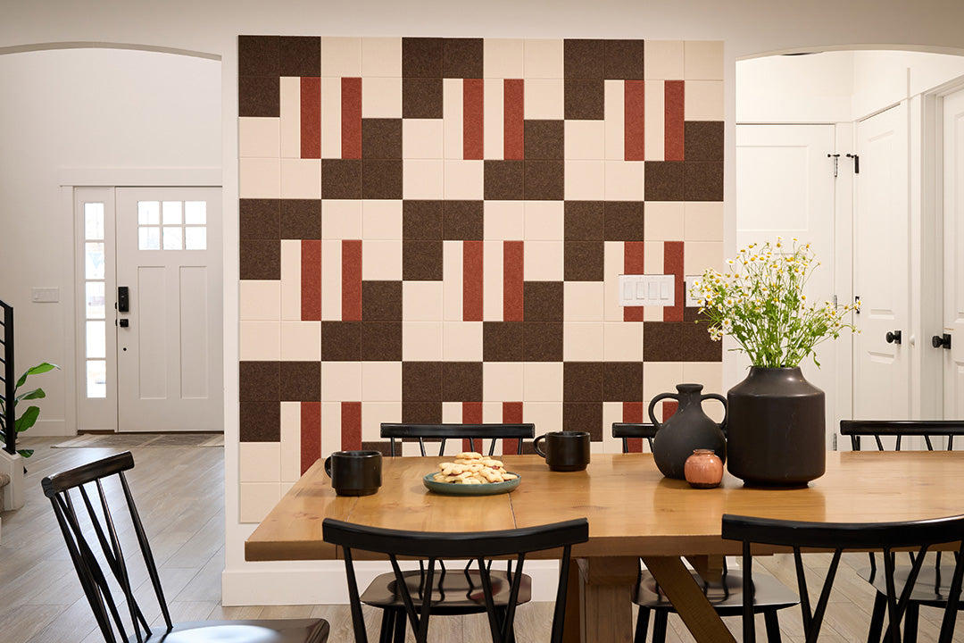 A Felt Right wall art design in shades of brown, red, and cream on a wall in a dinning room.